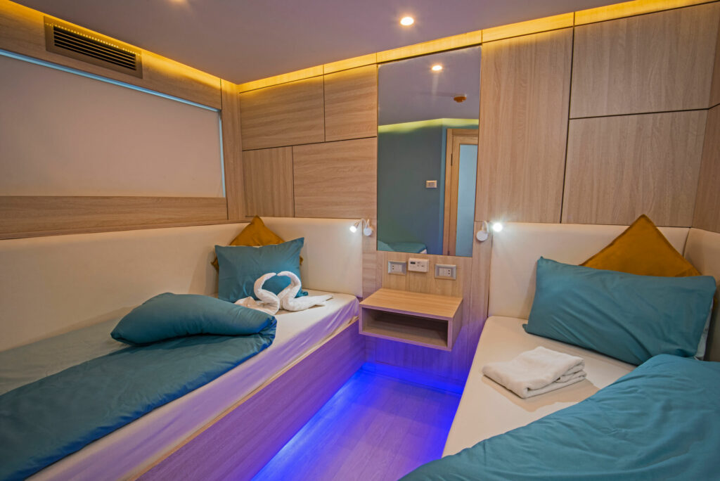 Interior of cabin bedroom on luxury sailing yacht with twin beds